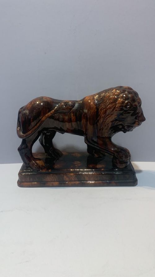 AN ANTUQUE TREACLE GLAZED LION - ADDITIONAL PHOTO 1