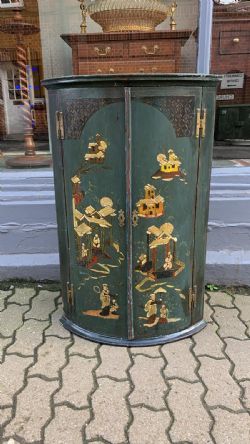 A GREEN GEORGE III CORNER CUPBOARD