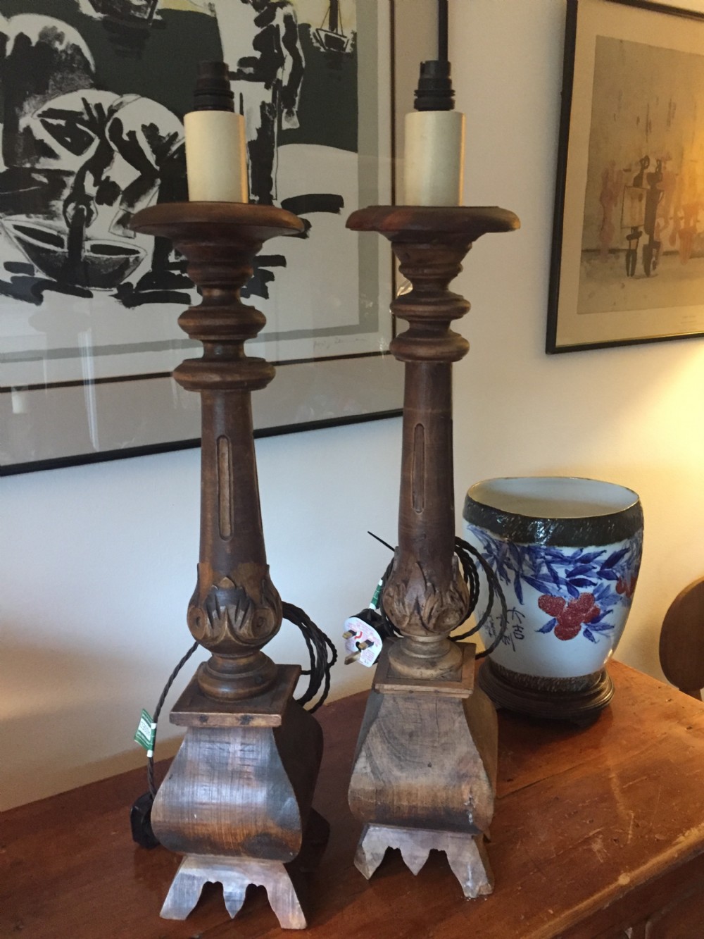 A near pair of tall 19th-century French carved oak table lamps featuring turned columns, leaf motifs, and flared stepped bases. View II