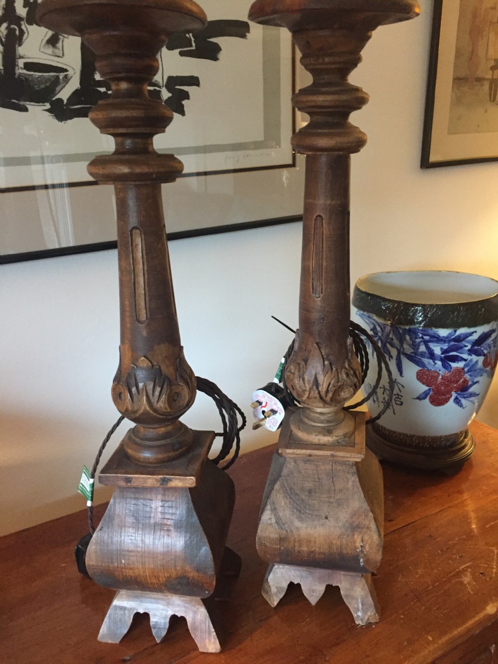 A near pair of tall 19th-century French carved oak table lamps featuring turned columns, leaf motifs, and flared stepped bases. View III