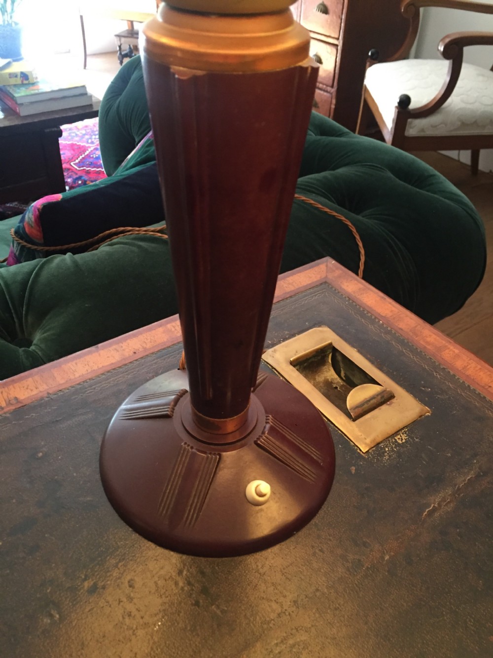 A near pair of Art Deco desk lamps featuring stepped dark brown Bakelite bases, fluted stems, and wide rounded metal shades with internal illuminated glass diffusers. View V