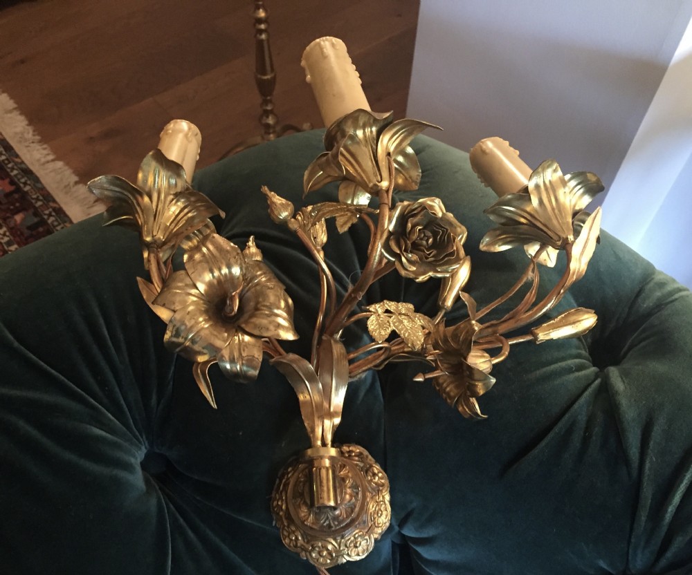 A pair of Art Nouveau gilt metal wall lights featuring three branches decorated with sculpted roses, lilies, and leaves holding candle-effect sockets. View III