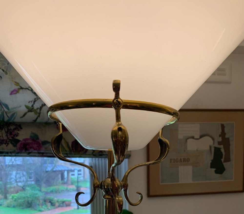 An Edwardian brass telescopic uplighter floor lamp featuring a tripod base, central column, and a wide white opaline glass shade. View III