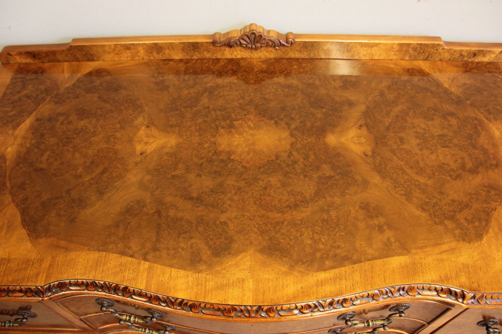 An antique burr walnut server side table featuring carved cabriole legs, brass drop handles, and a carved back gallery. View VIII