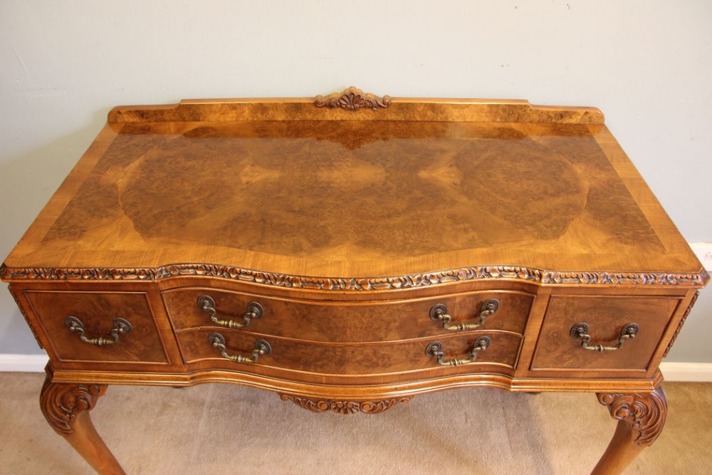 An antique burr walnut server side table featuring carved cabriole legs, brass drop handles, and a carved back gallery. View IX