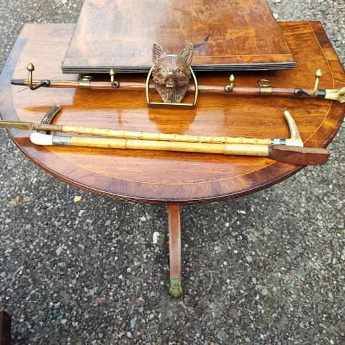 AN UNUSUAL CARVED FOX HEAD COUNTRY WHIP RACK