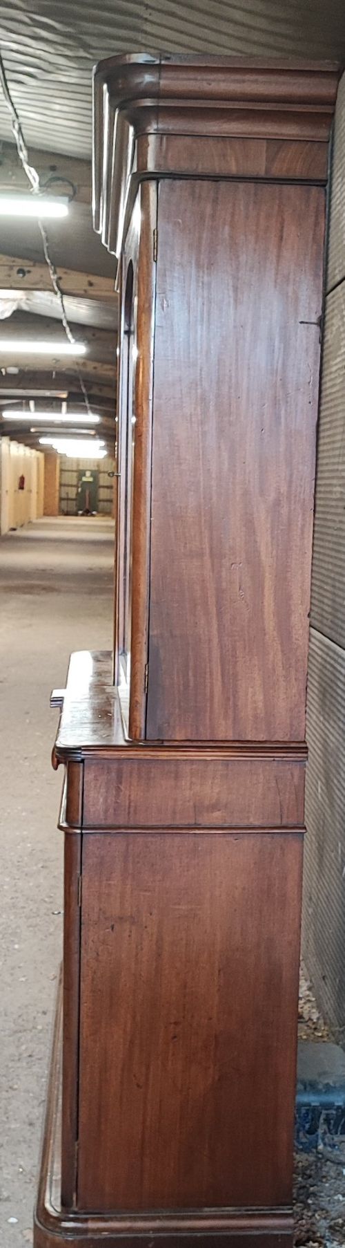 A tall Victorian mahogany bookcase featuring two glazed upper doors, two frieze drawers, and a double-door lower cupboard. View V