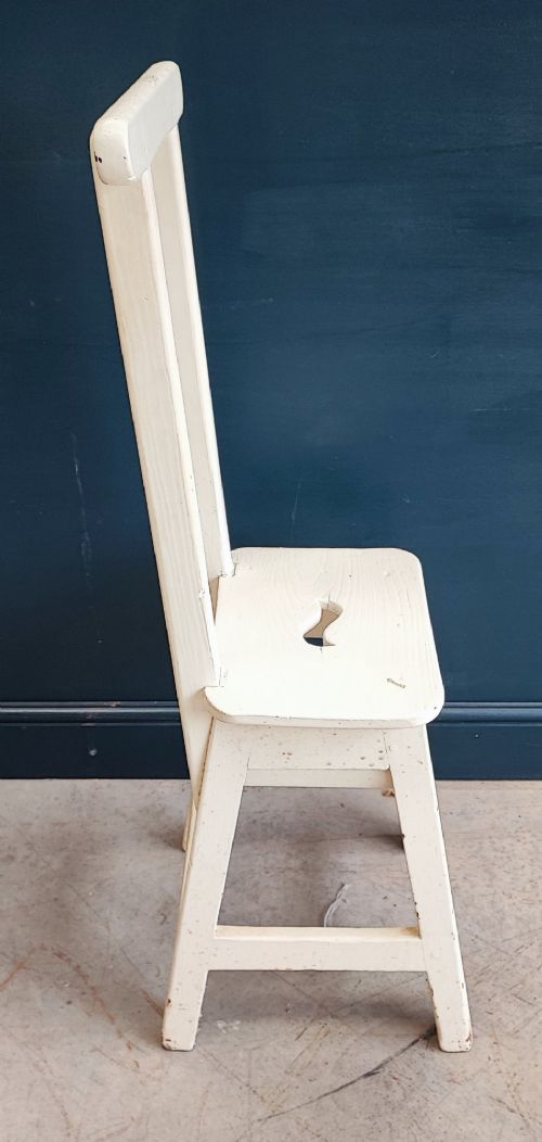 An off-white painted wooden step stool featuring a tall vertical back handle, splayed square legs, and a seat with a central carved handhole. View IV
