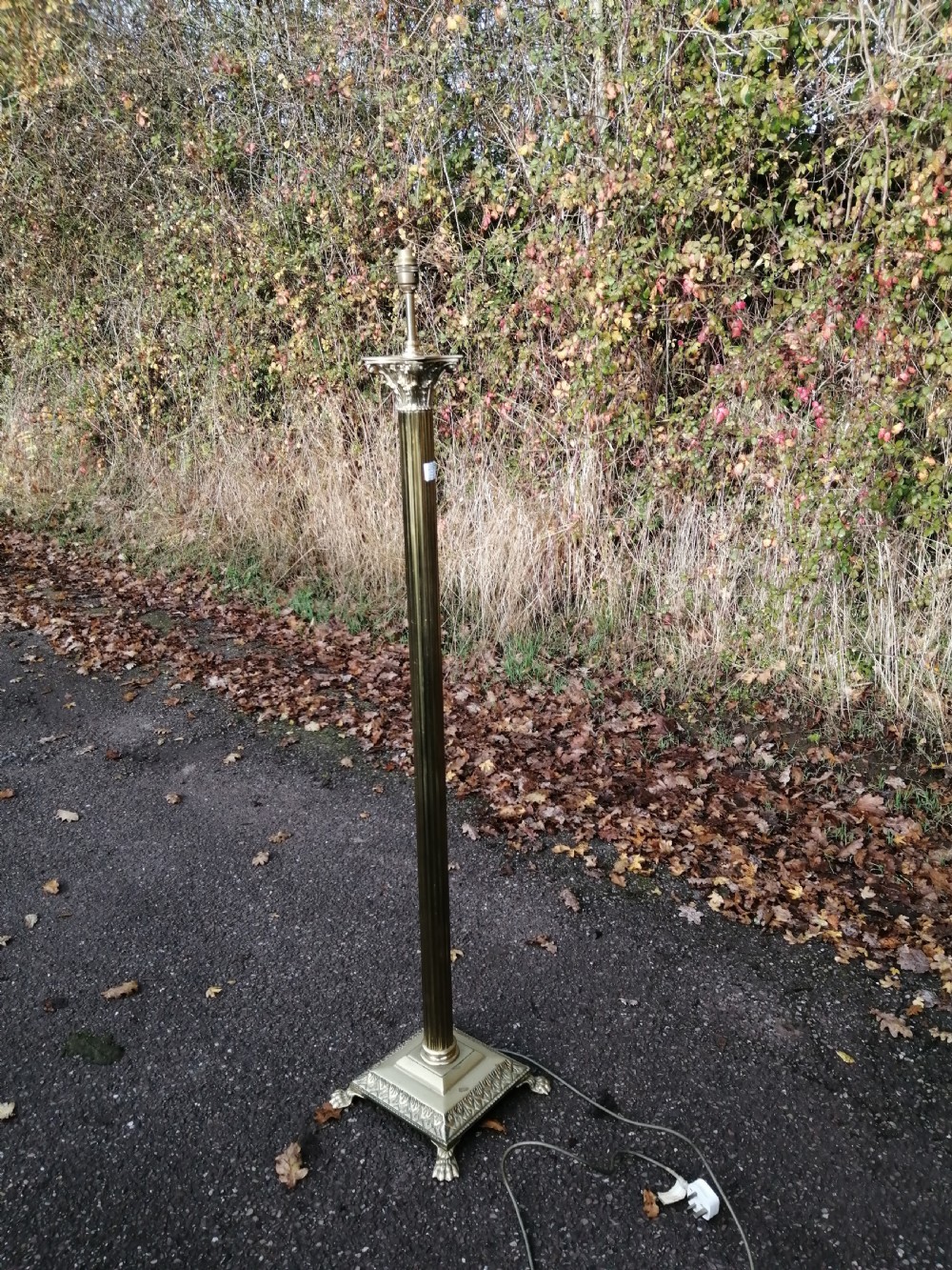 An antique brass Corinthian column standard lamp 