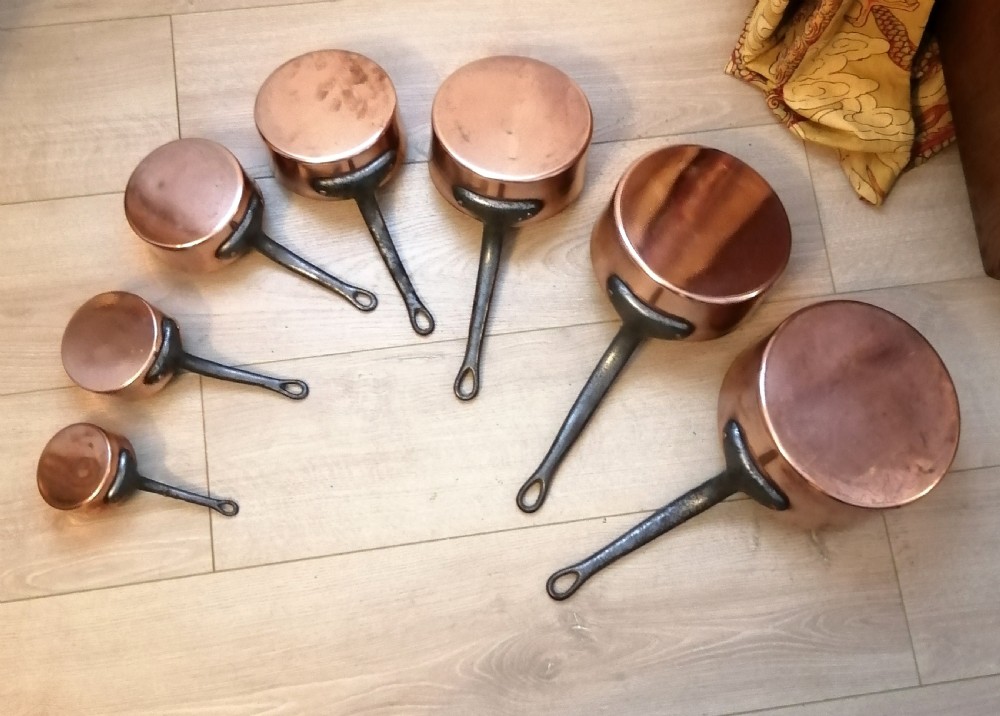 Antique set of 7 copper and steel French cooking pans.