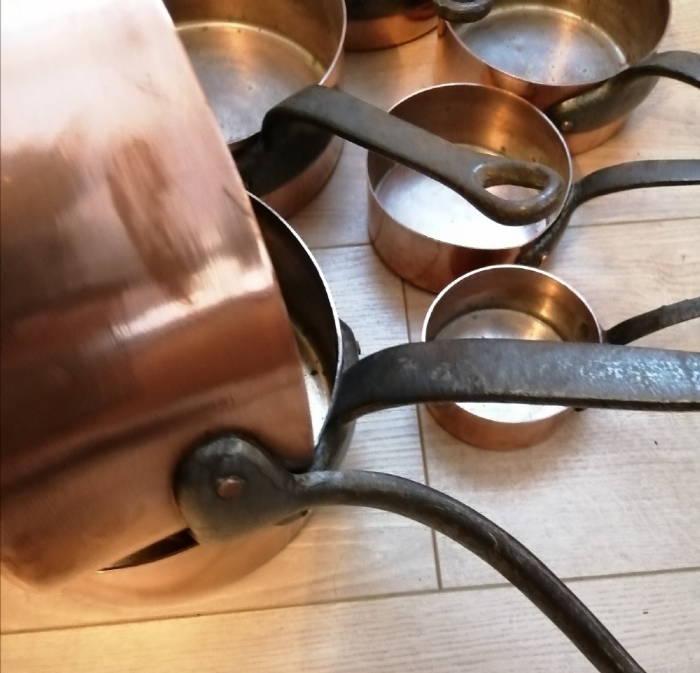 Antique set of 7 copper and steel French cooking pans. View II