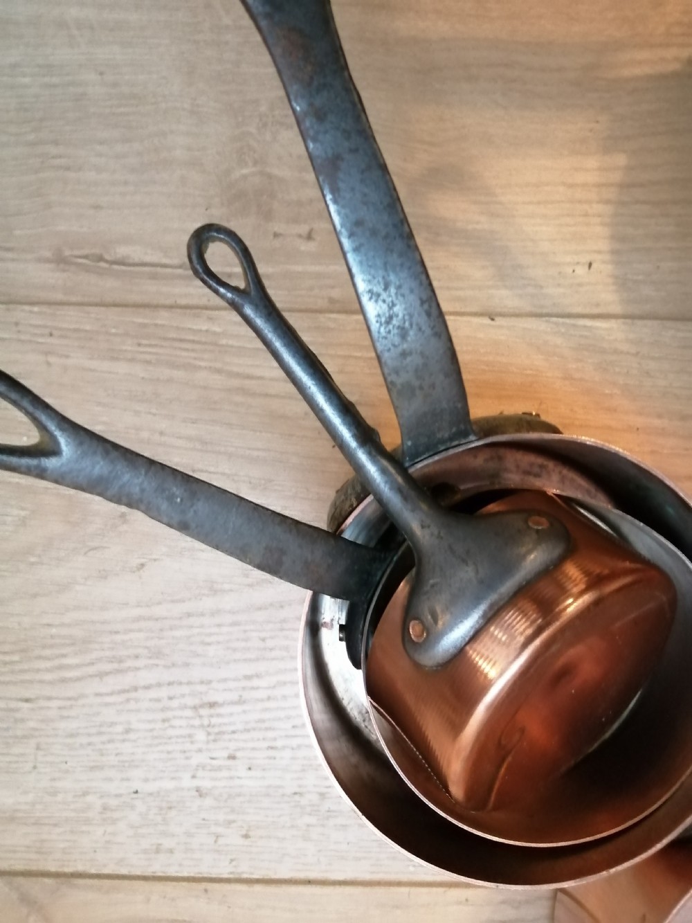 Antique set of 7 copper and steel French cooking pans. View VI