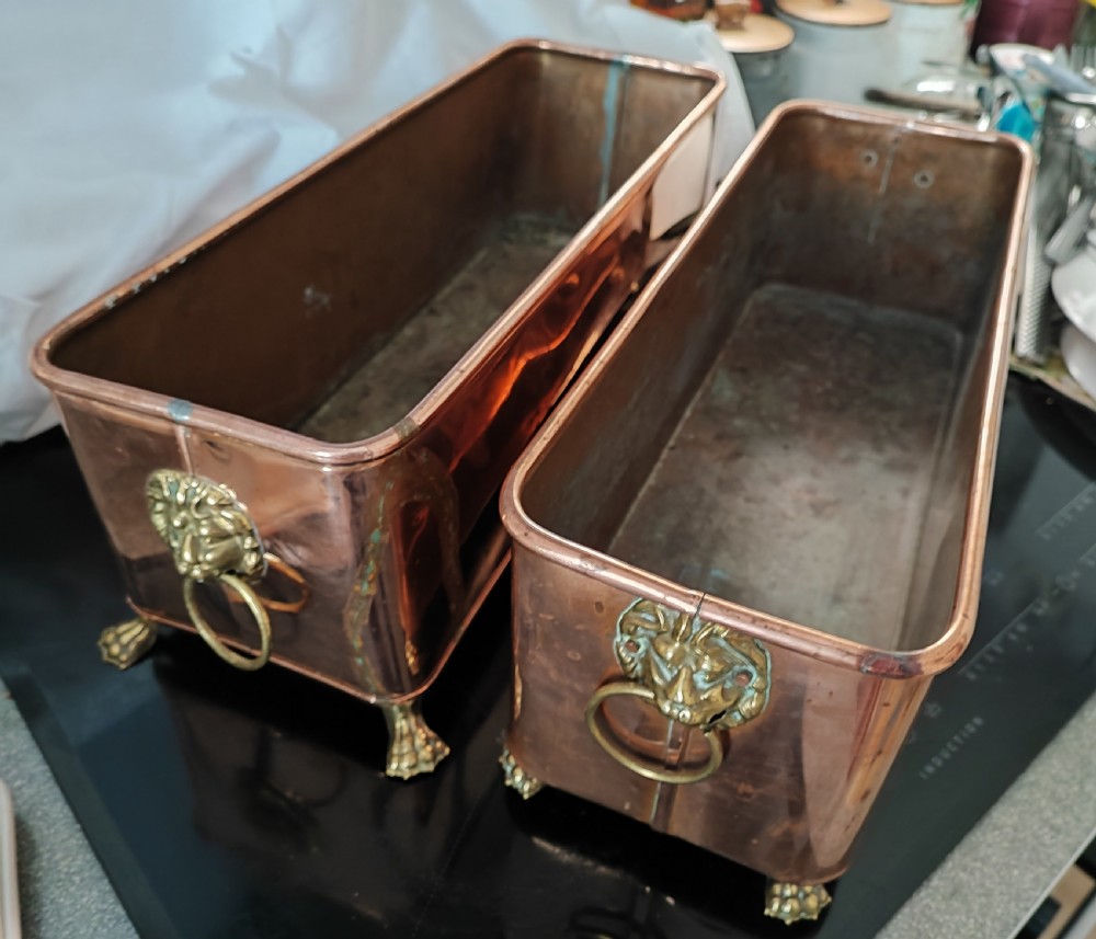 An antique pair of copper and brass planters.