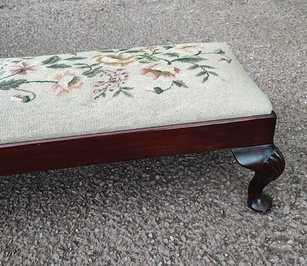 An antique long mahogany stool in the Queen Anne style. View II