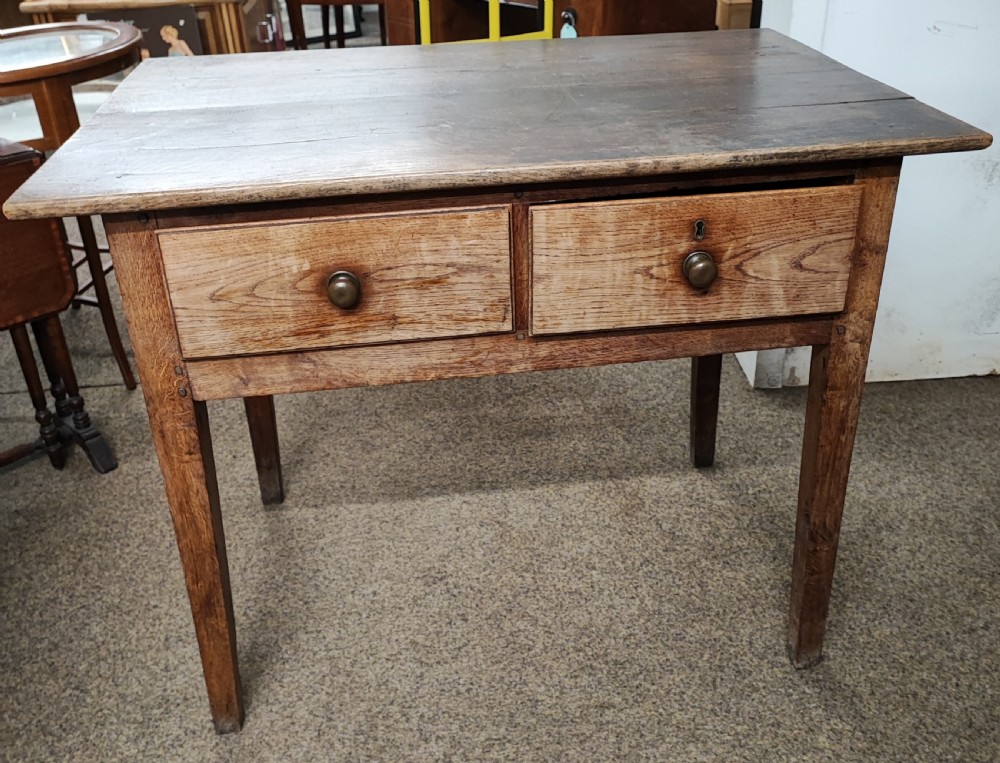 A small Georgian oak kitchen table.