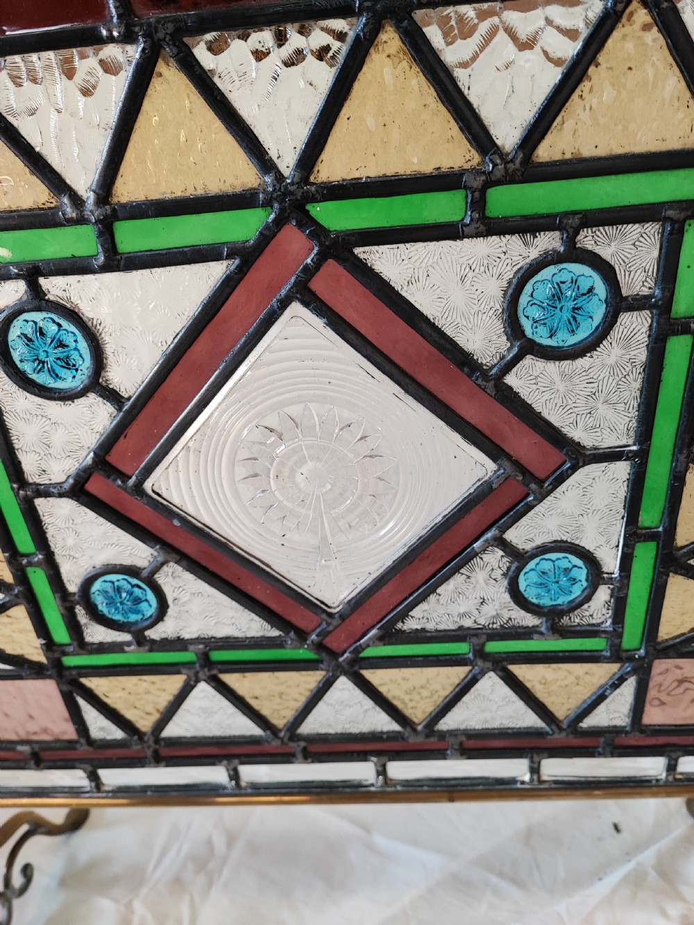 A Victorian brass framed stained glass firescreen. View V