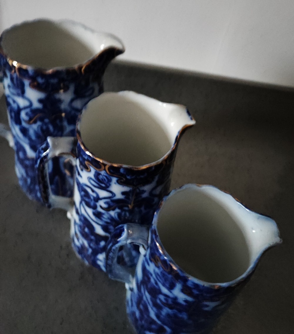 Good set of 3 Victorian Staffordshire flo Blue jugs. View VIII