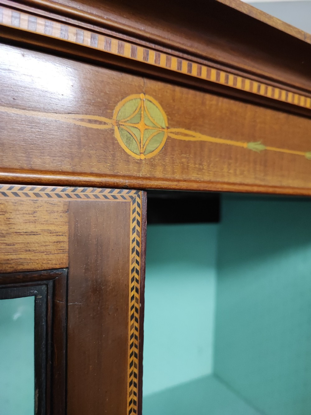 An Edwardian inlaid arts and crafts display cabinet. View II