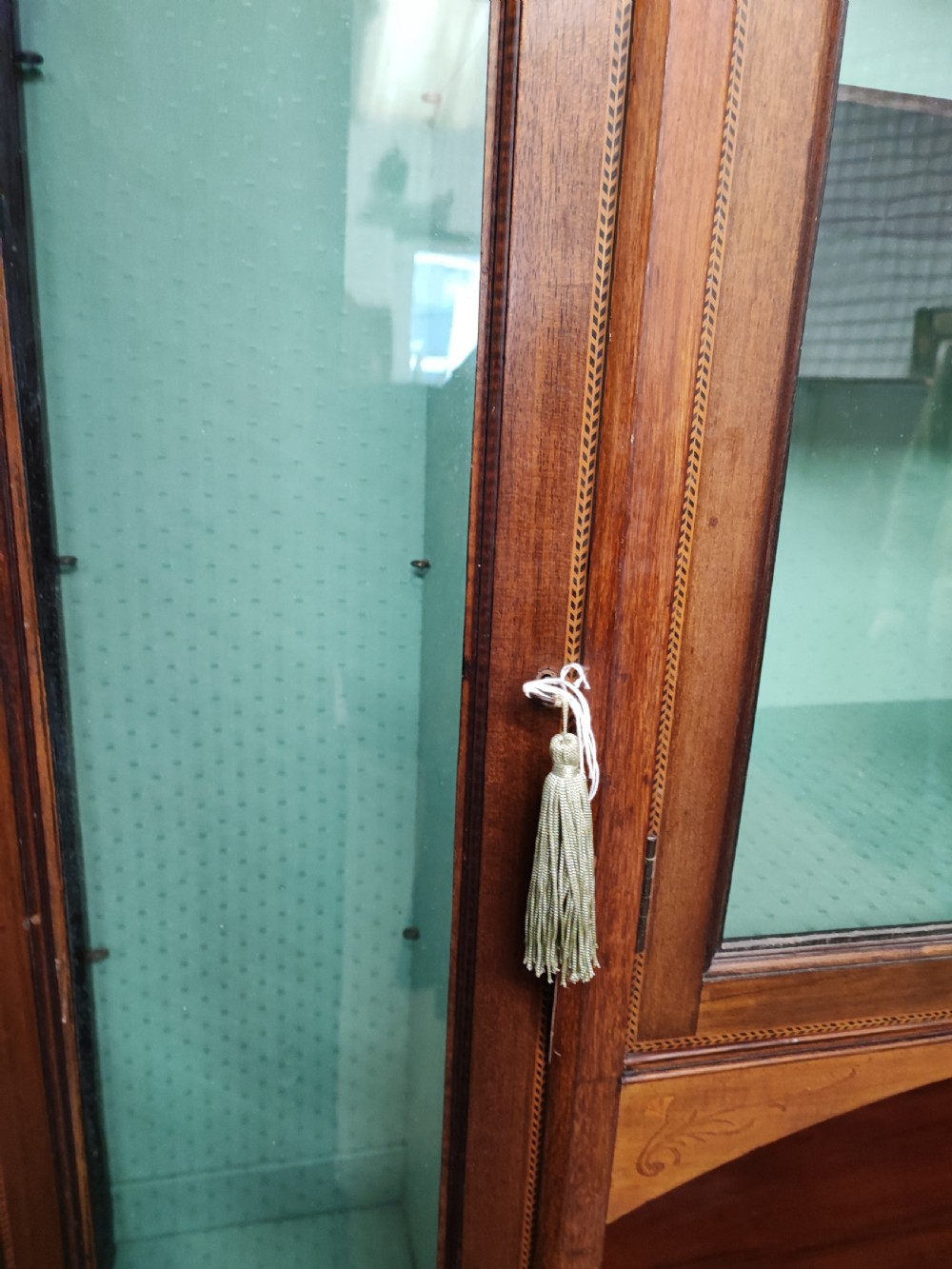 An Edwardian inlaid arts and crafts display cabinet. View V