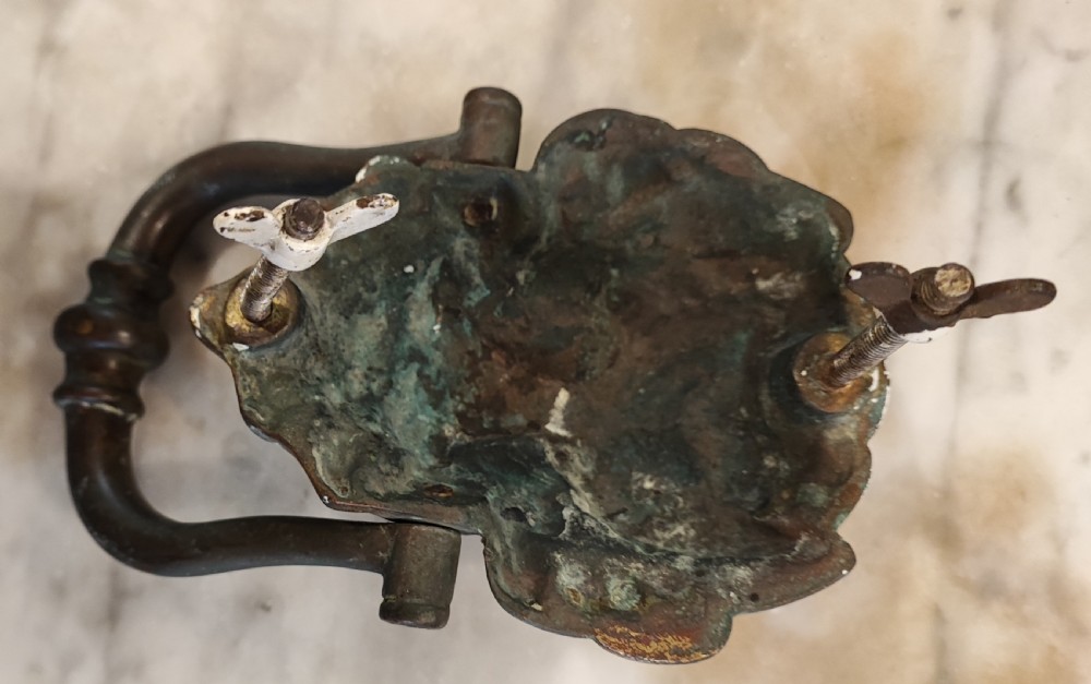 A Regency bronze lion head door knocker. In original condition. View V