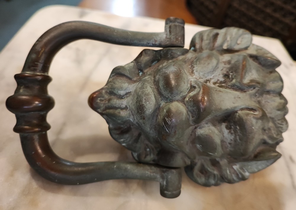 A Regency bronze lion head door knocker. In original condition. View VII
