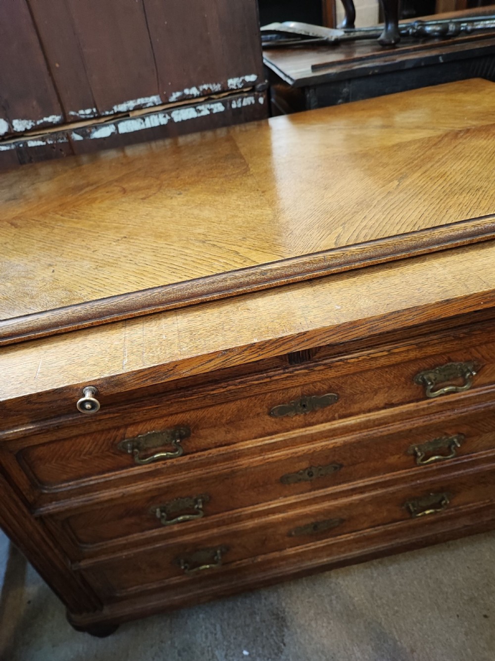 Antique French oak chest of drawers with writing slide. View IX