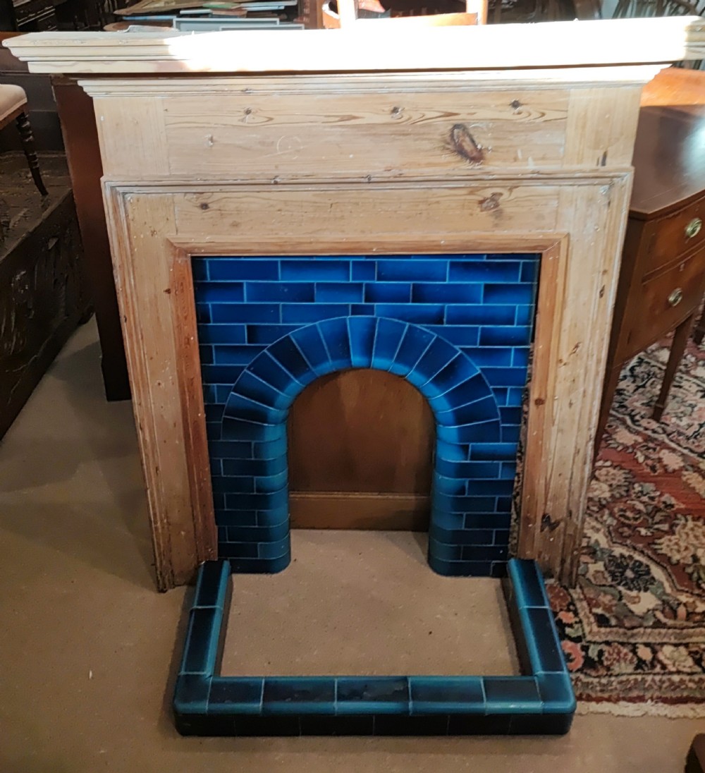 An antique pine fireplace and surround.
