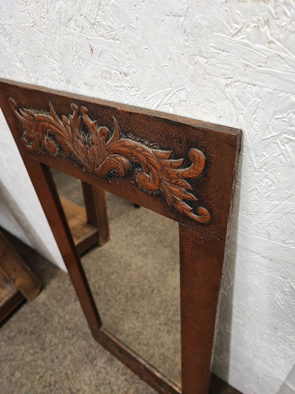 An antique arts and crafts copper framed mirror. View II