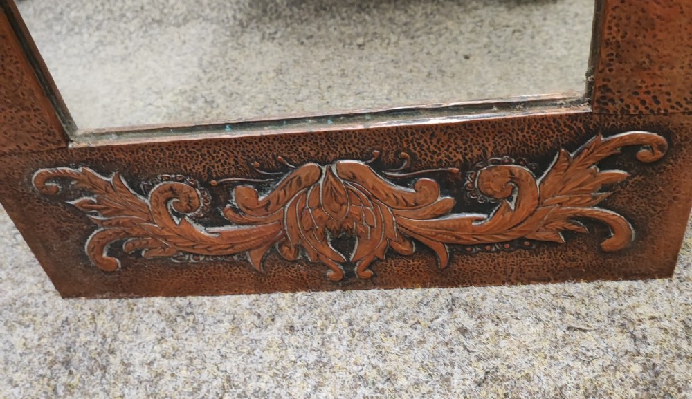 An antique arts and crafts copper framed mirror. View III