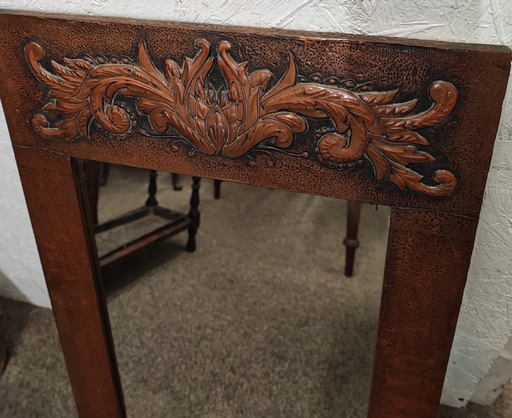 An antique arts and crafts copper framed mirror. View IV