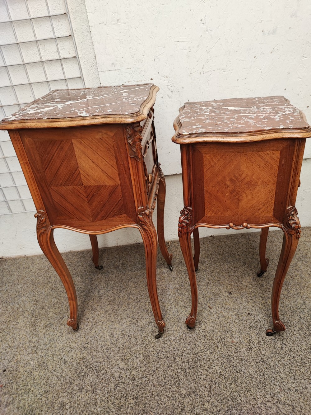 An antique matched pair of French marble top bedside cabinets.  View III
