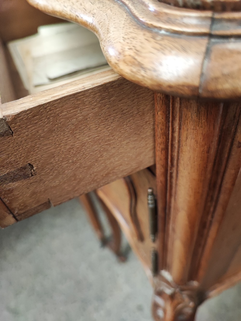 An antique matched pair of French marble top bedside cabinets.  View V