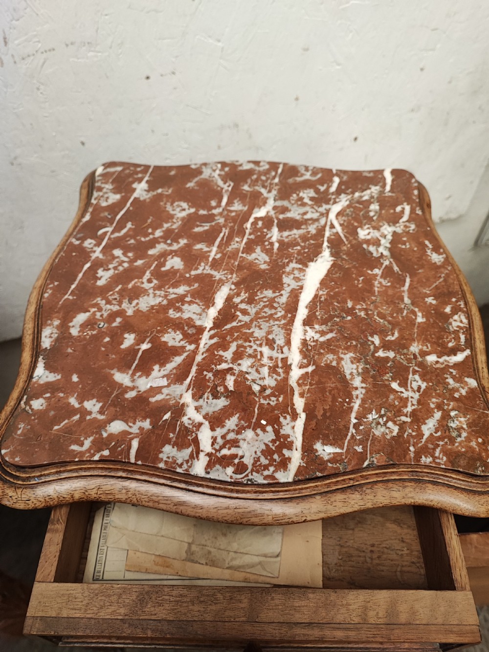 An antique matched pair of French marble top bedside cabinets.  View VIII