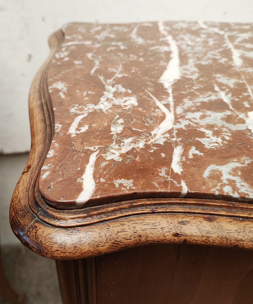 An antique matched pair of French marble top bedside cabinets.  View IX