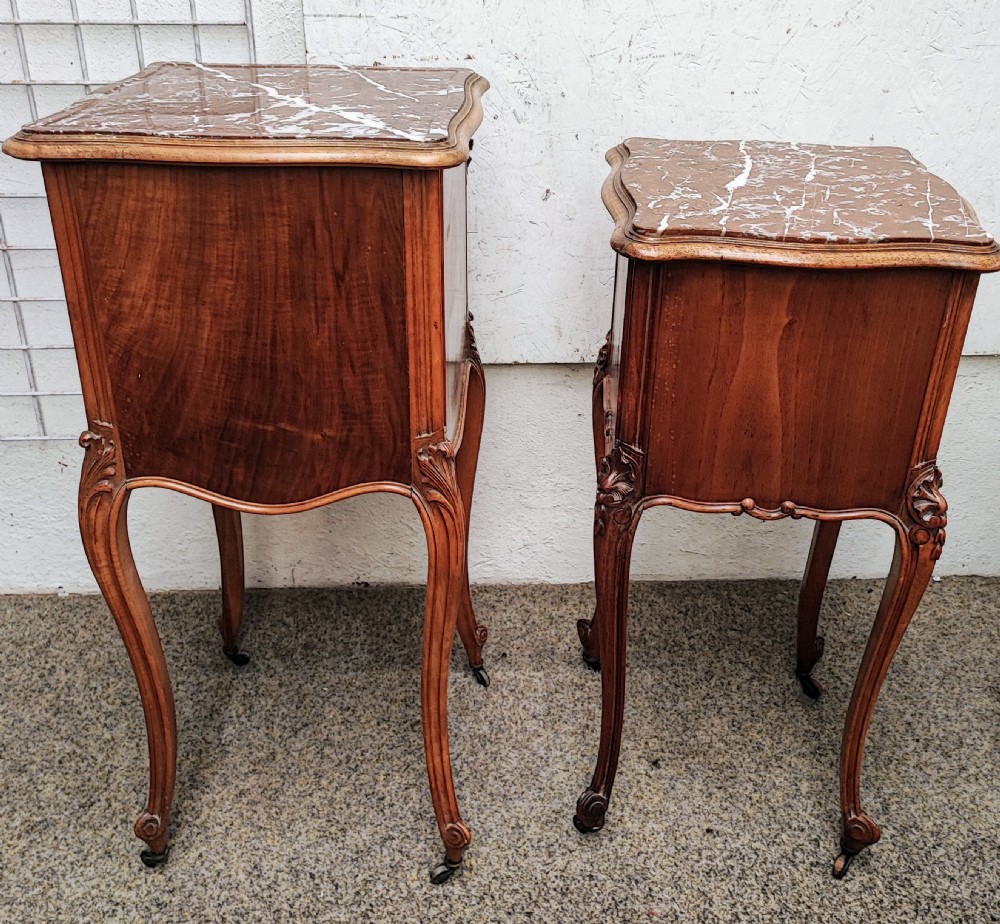 An antique matched pair of French marble top bedside cabinets.  View XII