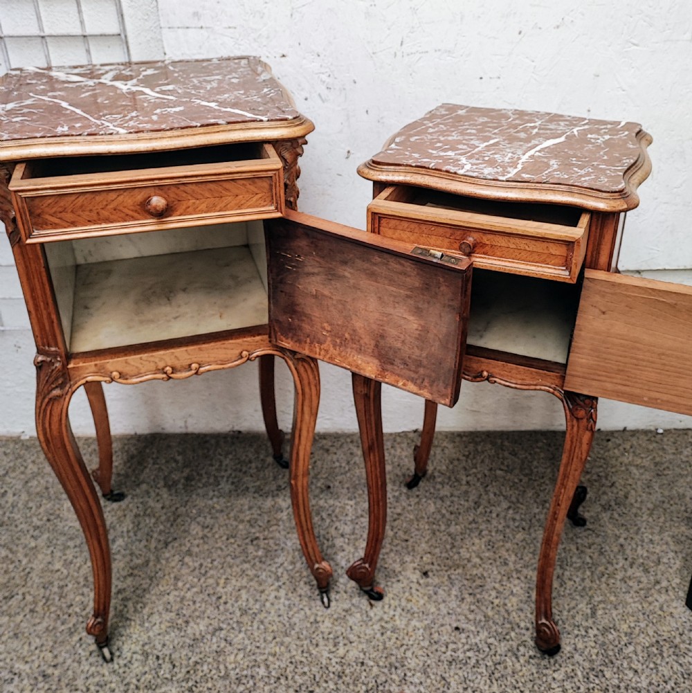 An antique matched pair of French marble top bedside cabinets.  View XIX