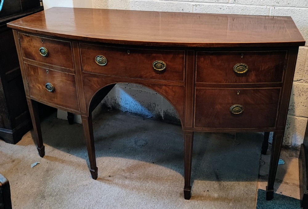 Antique inlaid mahogany bow front sideboard in the George III style.
