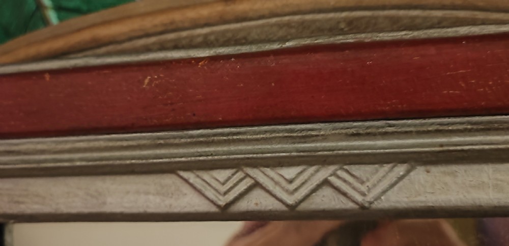 An English Art Deco wall mirror featuring a stepped geometric frame painted in terracotta red and off-white. View XV