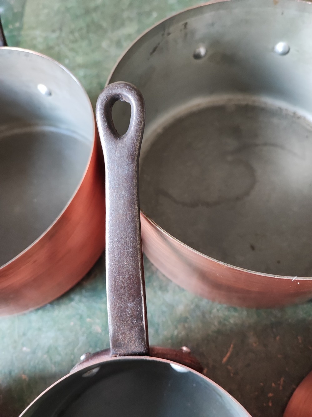 An antique Set of 5 French graduated copper and iron pans View II