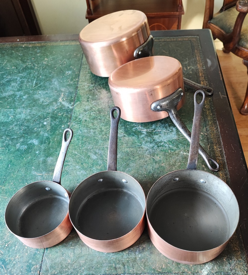 An antique Set of 5 French graduated copper and iron pans View III