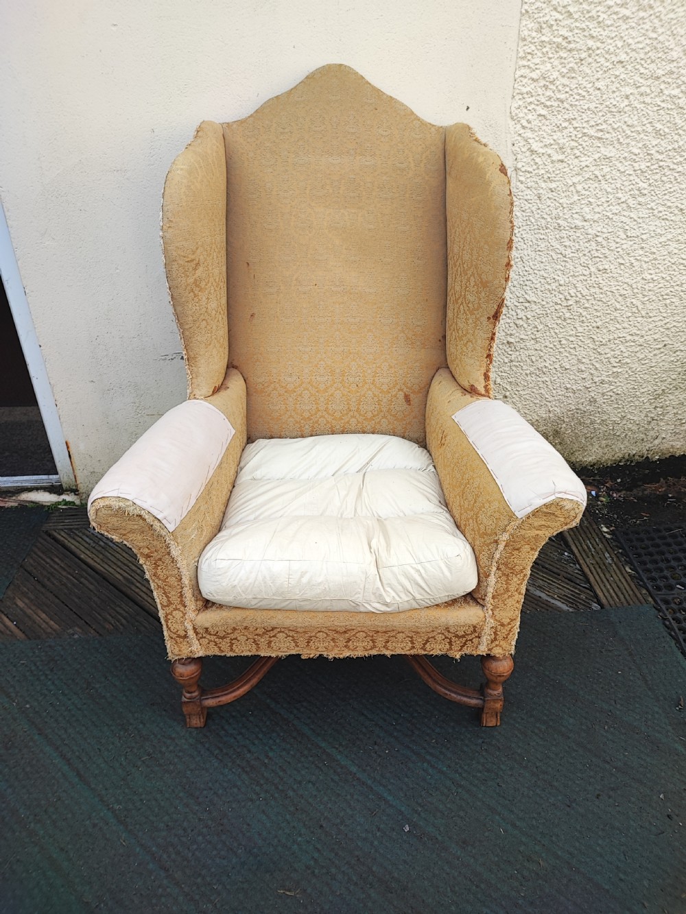 Substantial antique walnut wing chair,for reupholstery.