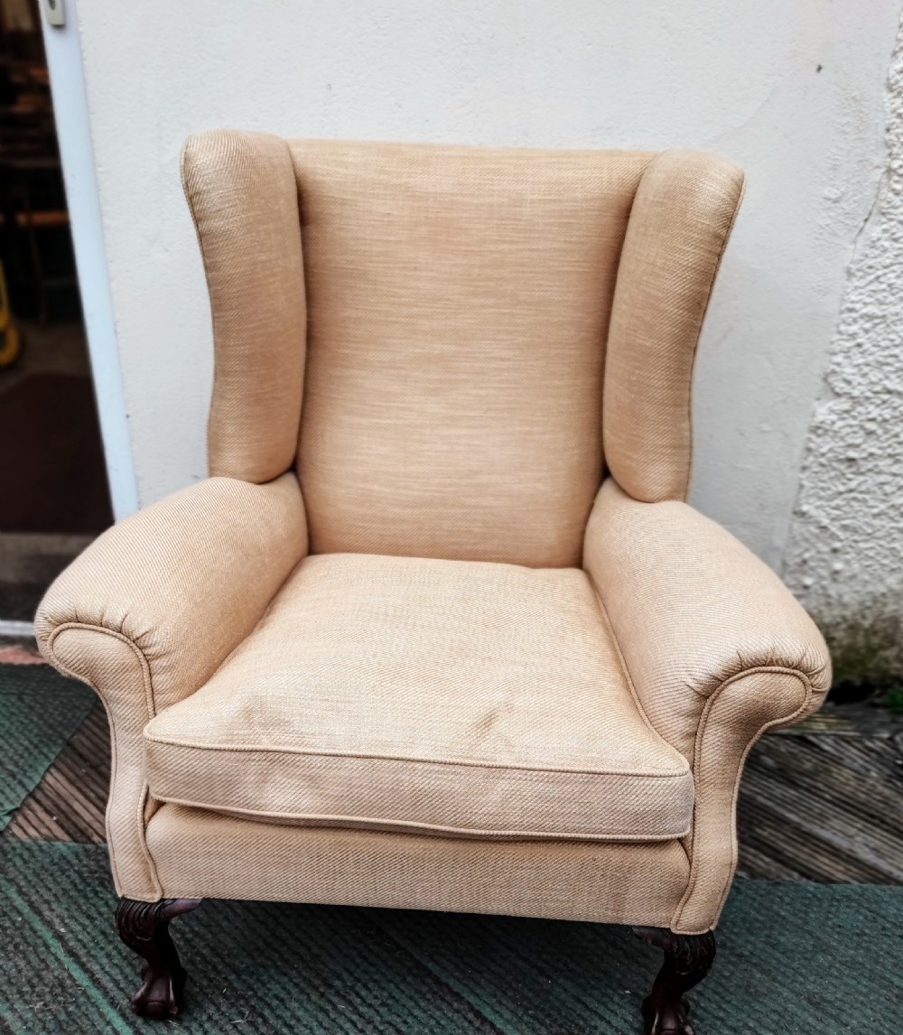 A 19c carved mahogany wing chair.