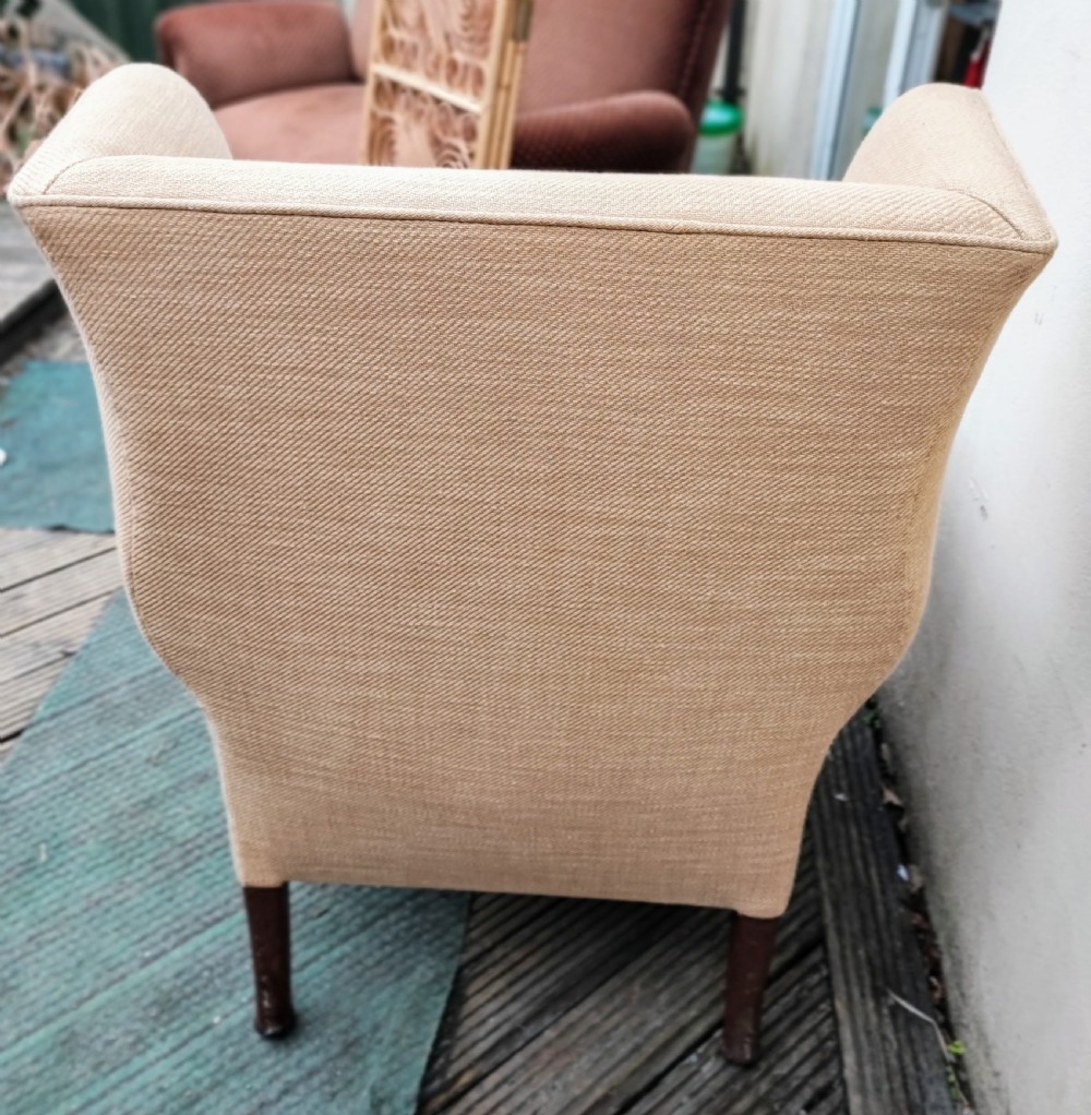 A 19c carved mahogany wing chair. View V