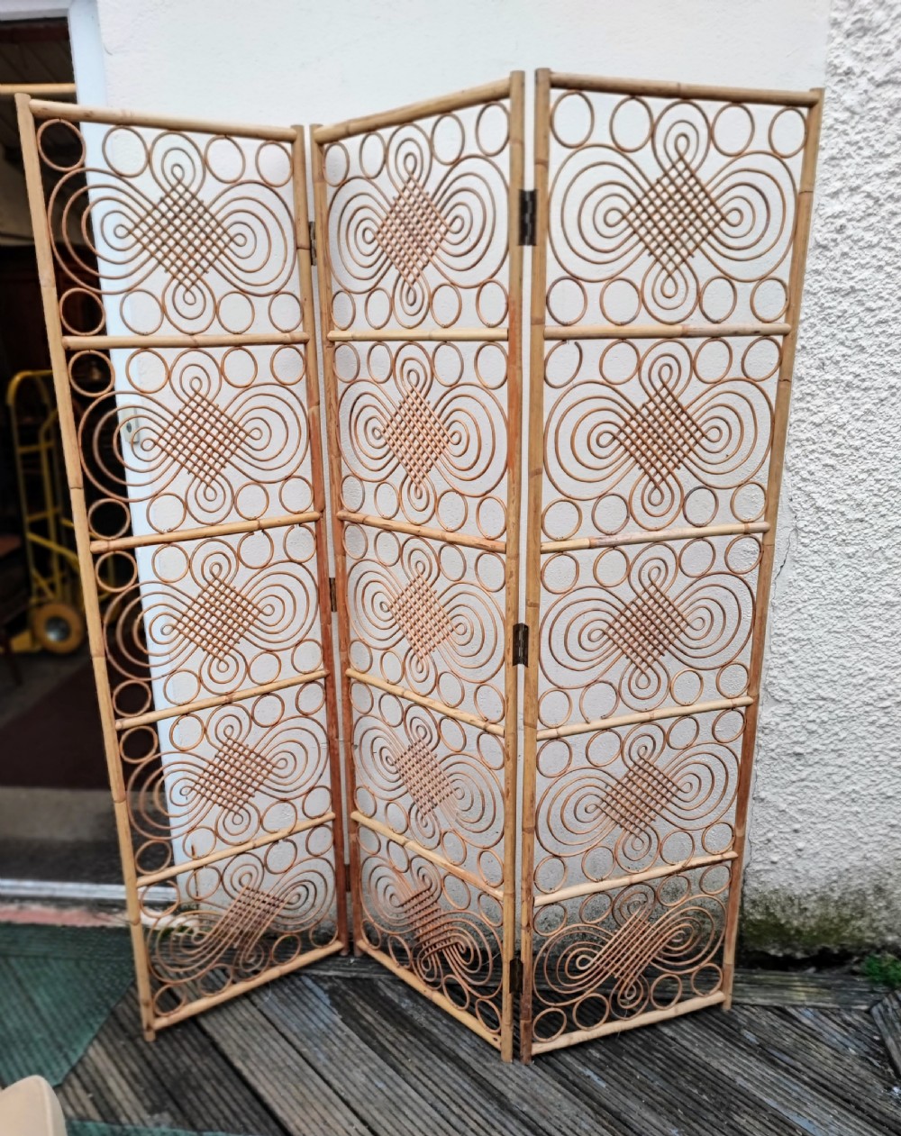 A decorative 3 fold bamboo screen.