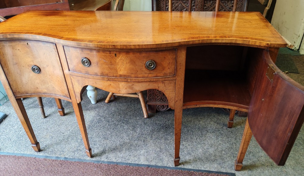 Antique mahogany, serpentine and inlaid sideboard in the George III style. View II