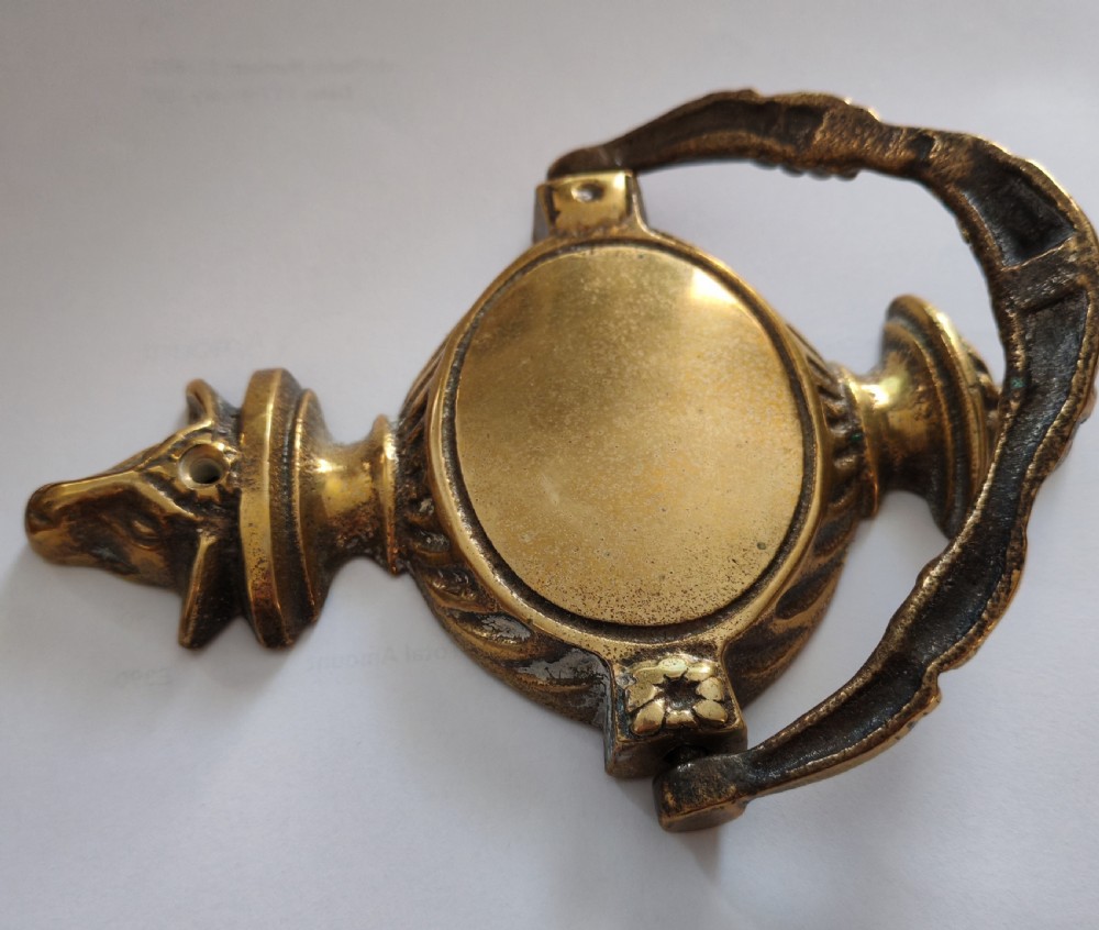 A cast brass Neoclassical style door knocker shaped like an urn with a floral patterned hinged ring. View VII