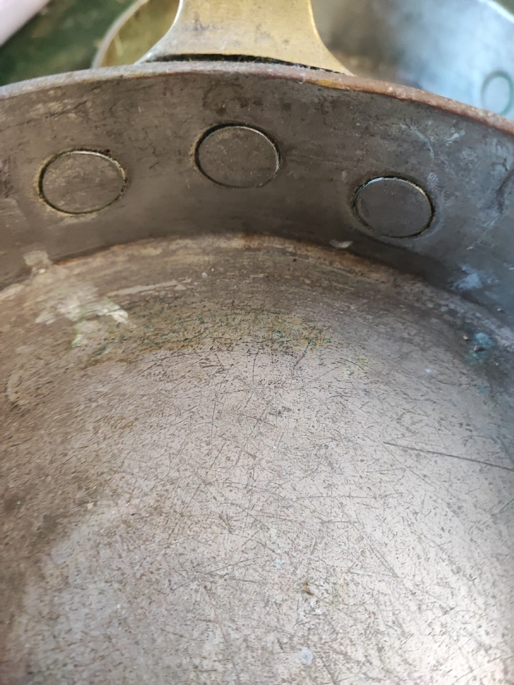 A set of five Victorian graduated copper saucepans featuring cast brass handles secured with heavy copper rivets. View II