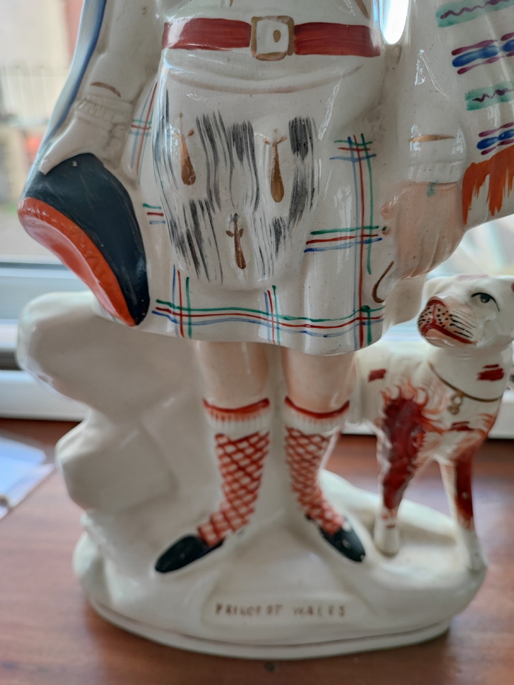 Victorian Staffordshire earthenware figure depicting the Prince of Wales in Scottish Highland attire alongside a hound. View V