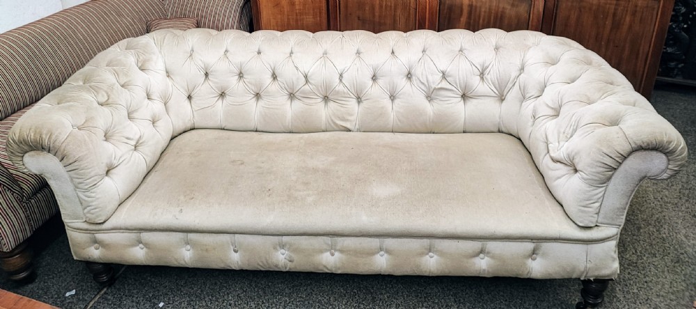 A large Victorian chesterfield sofa.