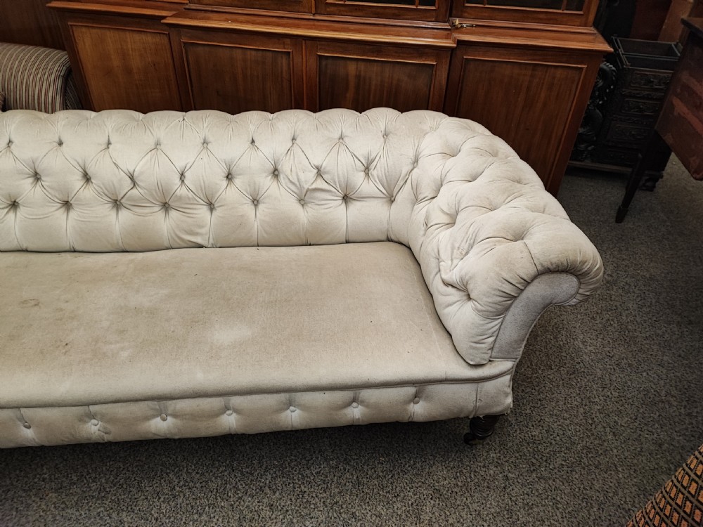 A large Victorian chesterfield sofa. View V